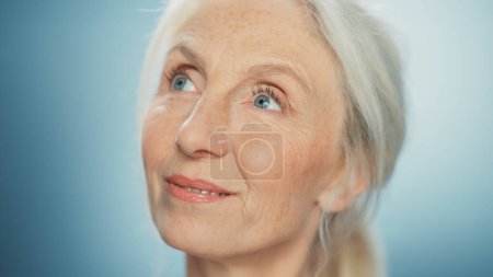 Photo for Close-up Portrait of Beautiful Senior Woman Looking Away Wonderfully. Gorgeous Looking Elderly Grandmother with Natural Beauty of Grey Hair, Blue Eyes - Royalty Free Image