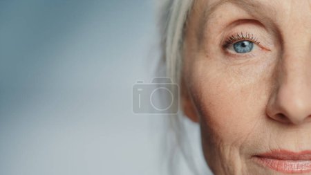 Foto de Primer plano Shot of an Eyes of Beautiful Senior Woman Looking at Camera and Smiling Wonderfully. Hermosa mirada anciana abuela con belleza natural - Imagen libre de derechos