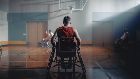 Photo for Wheelchair Basketball Game: Professional Player Prepairing to Play. He is Ready to Compete, Dribble Ball, Pass, Shoot it, Score a Goal. Concept with - Royalty Free Image