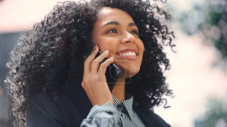 Photo for Close-up Portrait of Beautiful African American Businesswoman Talking on Smartphone. Successful Black Female Entrepreneur with Cute Smile and Curly - Royalty Free Image