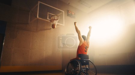 Photo for Wheelchair Basketball Play: Player Celebrating Perfect Goal with Raised Hands after Successful Shoot. Skill of a Winning Person with Disability. Low - Royalty Free Image