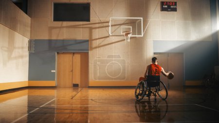 Photo for Wheelchair Basketball Player Wearing Red Shirt Dribbling Ball Like a Professional. Determination, Motivation of a Person with Disability Excelling at - Royalty Free Image