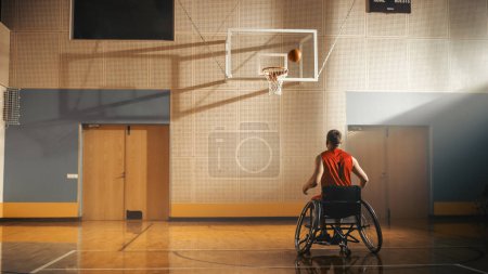 Photo for Wheelchair Basketball Player Successfully Shooting Ball, Scoring a Perfect Goal. Determination of a Person with Disability Moving Swiftly, Scoring - Royalty Free Image