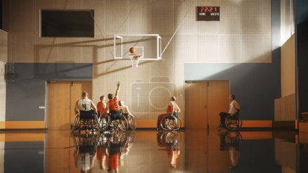 Téléchargez les photos : Jeu de basketball en fauteuil roulant : Joueurs professionnels en compétition, Dribbling Ball, Passage, Tirer avec succès, Marquer un but. Célébration de - en image libre de droit