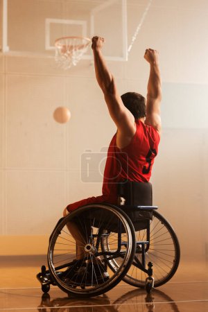 Photo for Wheelchair Basketball Play: Player Shooting Ball Successfully, Scoring a Perfect Goal, Celebrating with Raised Hands. Skill of a Winning Person with - Royalty Free Image
