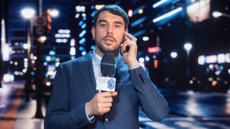 Anchorman Reporting Live News in a City at Night. News Coverage by Professional Handsome Reporter from a Business District. Journalist Presenting News