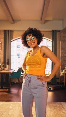 Vertical Screen: Beautiful Young Female Record a Dancing Routine on a Smartphone Video for Social Media. Stylish Black Girl in Glasses Streaming Her