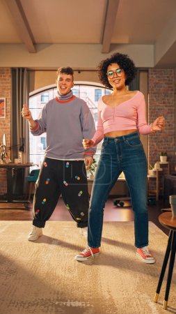 Vertical Screen: Beautiful Stylish Multiethnic Couple in Comfy Home Clothes Dancing and Enjoy Life at Home in Loft Apartment. Recording Funny Viral