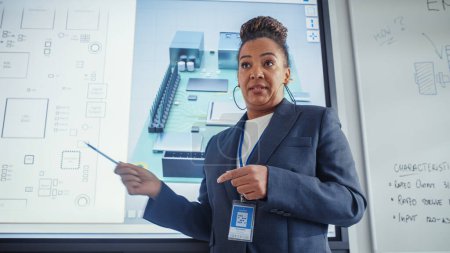 Photo for Black Female Teacher Uses Digital Interactive Whiteboard, Talks to Students and Shows 3D Computer Motherboard Components During Seminar. Intelligent - Royalty Free Image