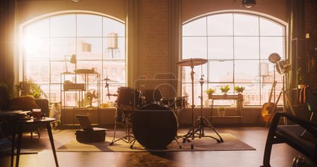 Téléchargez les photos : Establishing Shot: Music Rehearsal Studio in Loft Room with Drum Set in the Middle. Stylish Interior with Two Big Windows, Cozy Sofa, Shelves and - en image libre de droit