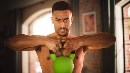 Foto de Home Gym Training: Handsome Muscular Black Man Lifting Heavy Kettlebell, Does Endurance Exercise. Strong Mixed Race Sportsman Workout. Energetic - Imagen libre de derechos