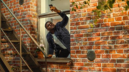 Distressed Young Black Man Doesnt Understand Why There is No Cellular Connection on His Smartphone, Frantically Reaching Out to the Sky with a Mobile