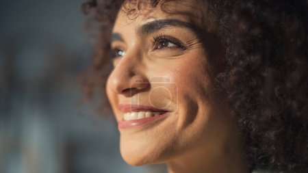 Close Up Portrait of a Multiethnic Brunette with Curly Hair and Brown Eyes. Happy Creative Young Woman Charmingly Smiling and Feeling Joyful. Thinking