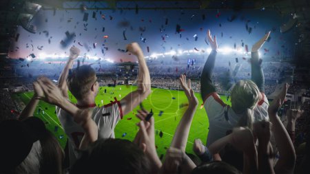Establishing Shot of Fans Cheer for Their Favorite Team on a Stadium During Soccer Championship Match. Team Scores Goal, Crowds of Fans Celebrate