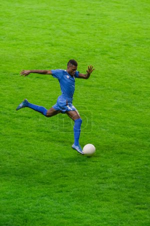 Vertical Shot: Major League Soccer Football Championship. Portrait of Blue Team Player Running, Determined to Win. Live Sport Channel, Broadcast