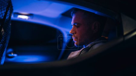 Photo for Close-up on the Culprit: Police Officers Arrest Suspect and Puts him in the Car. Regretful Face of a Criminal Thinking about Jail and Punishment - Royalty Free Image