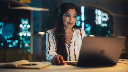 Photo for Indian Female Working in Creative Agency in the Evening, Implementing Modern Business Strategy for Clients. Successful Specialist Using Laptop - Royalty Free Image