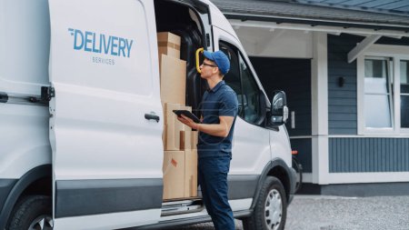 Courier Using Tablet Computer Next to Open Delivery Van Side Door with Cardboard Parcels. Mailman Delivering the Package to a Homeowner.