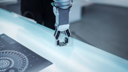 Close Up Footage of a Modern Robotic Arm Picking Up and Moving a Microchip. Engineer Interacting with the Robot Hand By the Means of Virtual Reality