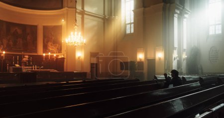 A Devout Christian Sits Piously in a Grand Old Church, Contemplating Earthly Life and Mortality. Person Seeking Moral Guidance From the Faith