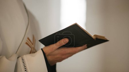 In Christian Church: Close Up of The Bible, Gospel of Jesus. Minister Leads The Congregation In Prayer and Reads From The Holy Book, Priest Providing