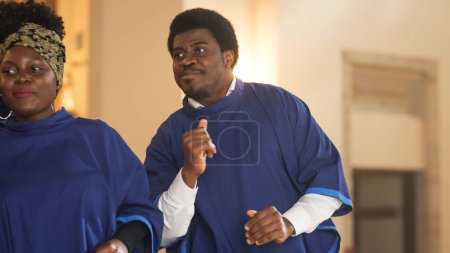 Black Christian Male Gospel Singer Singing, Happy to be Spreading the Love of Lord Jesus Christ. Cheerful African American Man in Blue Robe in Sunday
