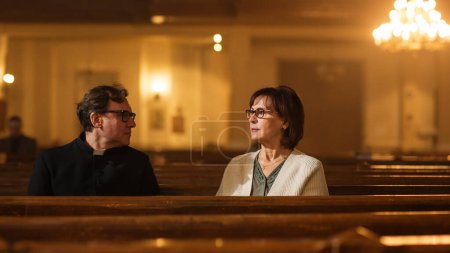Talk in Church: The Pastors Gentle Voice Brings Comfort and Solace To Senior Parishioner. With Gentle Words of Reassurance He Reminds Woman of the