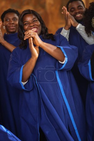 Black Christian Gospel Singers in Church Clapping and Stomping, Praising Lord Jesus Christ. Song Spreads Harmony Joy and Faith. Energetic Choir