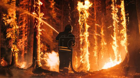 Experienced Firefighter Extinguishing a Wildland Fire Deep in the Woods. Professional in Safety Uniform and Helmet Spraying Water to Fight Large