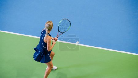 Female Tennis Player About to Server Ball with a Racquet During Championship Match. Professional Woman Athlete Strikes Successfully. World Sports