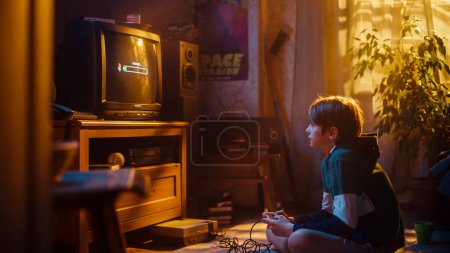 Nostalgic Childhood Concept: Young Boy Playing an Old-School Arcade Video Game on a Retro TV Set at Home in a Room with Period-Correct Interior. Niño.