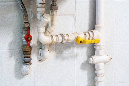Photo for Home gas pipe installation, pipes at an old house, gas powered water heater in a bathroom or a kitchen, various pipes and valves object detail, closeup, nobody, no people. Gas and water pipes at home - Royalty Free Image