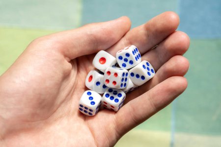 Photo for Man holding a few small game dice showing different numbers in hand, group of objects closeup. Math randomness, entropy, probability and statistics, education subject abstract concept, one person - Royalty Free Image