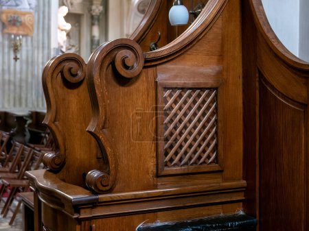 Photo for Simple wooden confessional in a church closeup detail, nobody, no people. Confession, confessing sins religious concept Christianity, Catholicism forgiveness and mercy, church interior detail up close - Royalty Free Image
