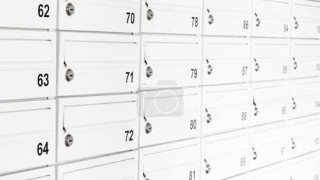 Photo for Lots of white private mailboxes, wall of many letterboxes in a flat apartment condo complex, object detail, closeup. Postal service, receiving mail messages abstract concept, nobody - Royalty Free Image