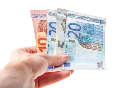 Photo for Man holding, giving out away a few Euro banknotes in hand, small bills, European currency simple concept One person, salary bonus, earning money and payment, paying with cash, tipping, bribing gesture - Royalty Free Image