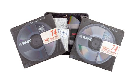 Photo for Retro small Sony Mini Disc set top view, objects isolated on white background, cut out, worn out old obsolete music data magnetic storage format 3 BASF minidiscs nobody - Royalty Free Image