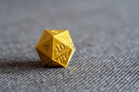 Photo for Golden 3D printed d20 RPG game dice on a bed object macro detail, extreme closeup, nobody. Playing tabletop RPG board games, larp and 3d printing accessories, geek nerd culture symbol abstract concept - Royalty Free Image