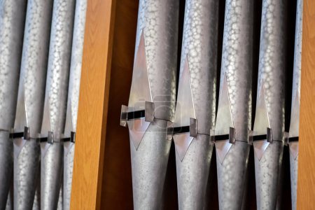 Pipe organ metal pipes in a row up close detail nobody. Religious music service, pipe organ musical concert, classical music symbol, church instruments simple abstract concept, no people, organist gig