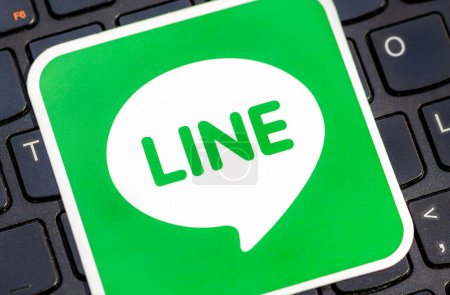 Photo for Close-up view of the green LINE messaging application logo icon, with the apps distinctive green chat bubble logo, computer keyboard. Instant messaging apps concept - Royalty Free Image