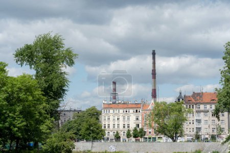 Photo for Wroclaw, Poland, two tall chimneys over the city buildings, wide angle shot, city architecture, heat power plant in a large city simple concept, co2 emissions, nobody - Royalty Free Image