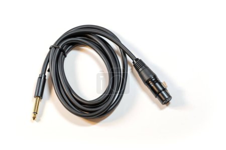 Coiled black audio cable featuring a 1 4 inch jack on one end and an XLR male connector on the other, isolated on white background, nobody. Professional mic microphone studio cable object, nobody