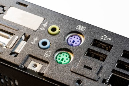 Close-up view of a computer motherboard featuring old obsolete no longer used PS 2 ports for keyboard and mouse along with USB connections old technology unused standard, nobody, object closeup detail