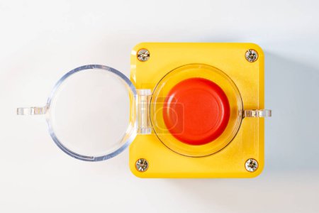 Large red emergency stop button see from above, top view, with open cover, industrial workplace safety, heavy-duty machine stop mechanism, asset on white background, nobody. Machinery panic button