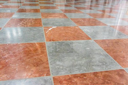 Photo for Red and white marble floor with alternating colored stone tiles viewed at a low angle with oblique perspective - Royalty Free Image