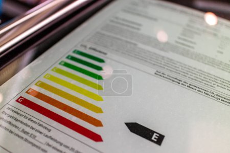 Téléchargez les photos : Certificat énergétique pour la consommation d'électricité aux appareils de catégorie et aux logements domestiques dans l'Union européenne avec un graphique à barres colorées et pointeur de flèche - en image libre de droit