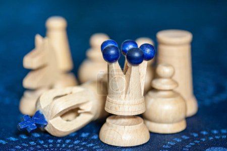 Photo for Details of white wooden chess pieces, King is knocked over signifying end of game. - Royalty Free Image