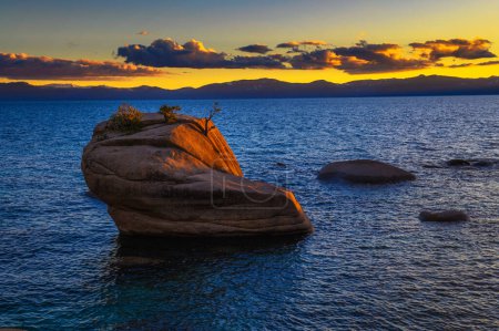 Photo for Dramatic sunset over the Bonsai Rock of Lake Tahoe, with Sierra Nevada Mountains in the background. - Royalty Free Image