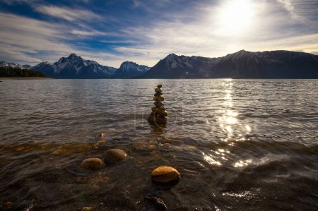 Photo for Balanced rock pyramid at the Jackson Lake with Grand Teton Mountains in the background in Wyoming, USA, photographed at sunset. - Royalty Free Image