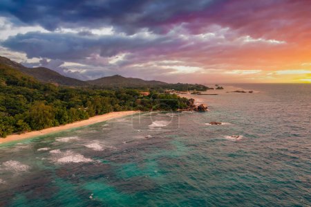 Photo for Aerial sunset view of Anse Severe Beach at the La Digue Island, Seychelles. This beautiful white-sand beach is famous for its turquoise, shallow waters and sunset views. - Royalty Free Image
